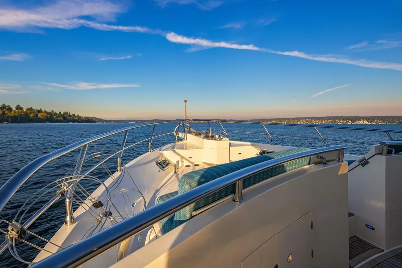 La Bella Vita II Yacht Photos Pics Luxurious 2014 Hampton 720 Skylounge LRC yacht cruising on serene waters at sunset.