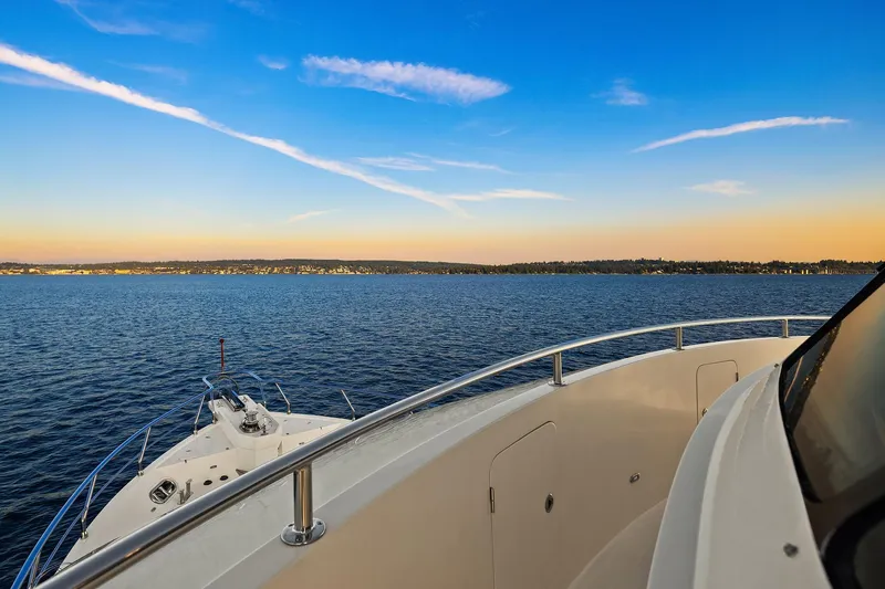 La Bella Vita II Yacht Photos Pics 2014 Hampton 720 Skylounge LRC yacht cruising on serene blue waters at sunset.
