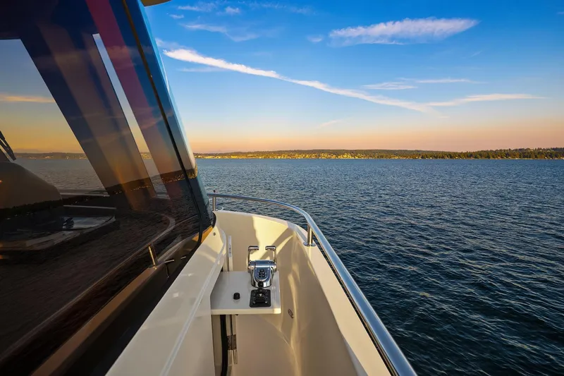La Bella Vita II Yacht Photos Pics 2014 Hampton 720 Skylounge LRC yacht cruising on serene waters at sunset.