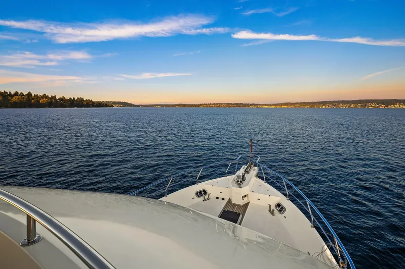 La Bella Vita II Yacht Photos Pics Bow view of 2014 Hampton 720 Skylounge LRC yacht on serene water under blue sky.