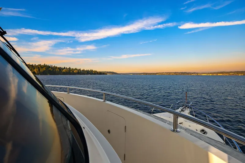 La Bella Vita II Yacht Photos Pics 2014 Hampton 720 Skylounge LRC yacht cruising on serene waters at sunset.