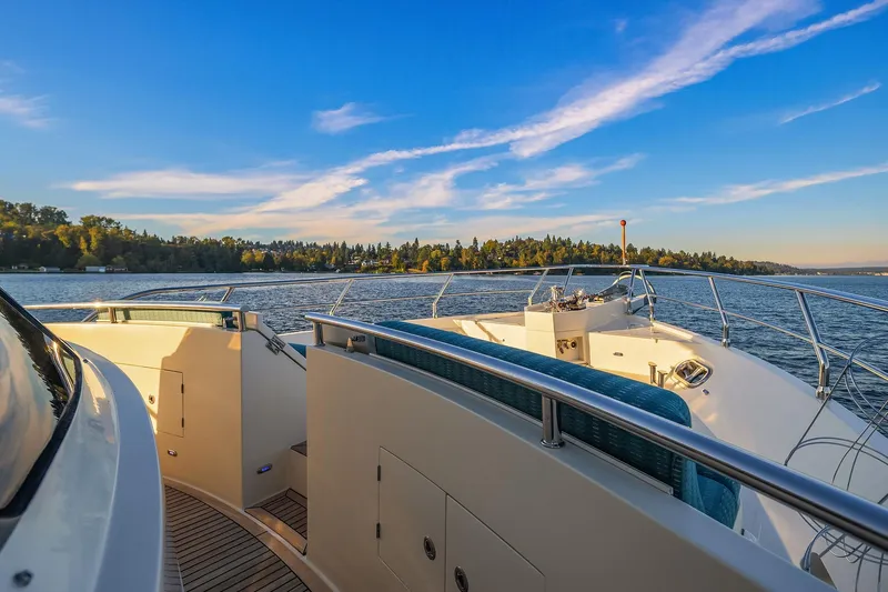 La Bella Vita II Yacht Photos Pics Luxurious 2014 Hampton 720 Skylounge LRC yacht cruising on a serene lake under a clear blue sky.
