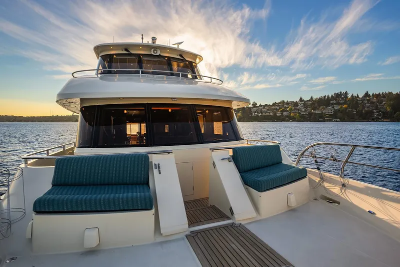 La Bella Vita II Yacht Photos Pics Luxurious 2014 Hampton 720 Skylounge LRC yacht on serene water at sunset.