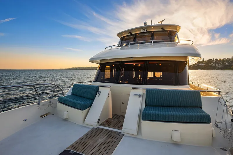 La Bella Vita II Yacht Photos Pics 2014 Hampton 720 Skylounge LRC yacht on serene water at sunset.