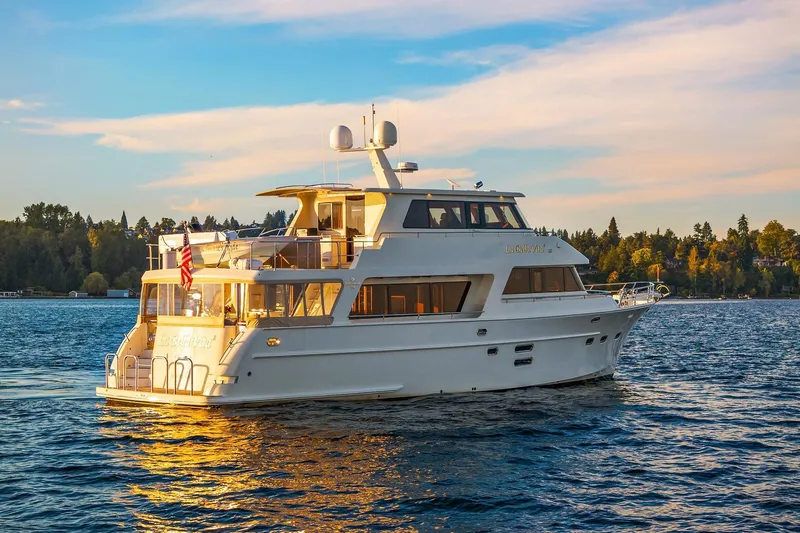 La Bella Vita II Yacht Photos Pics Luxury 2014 Hampton 720 Skylounge LRC yacht on serene water at sunset.