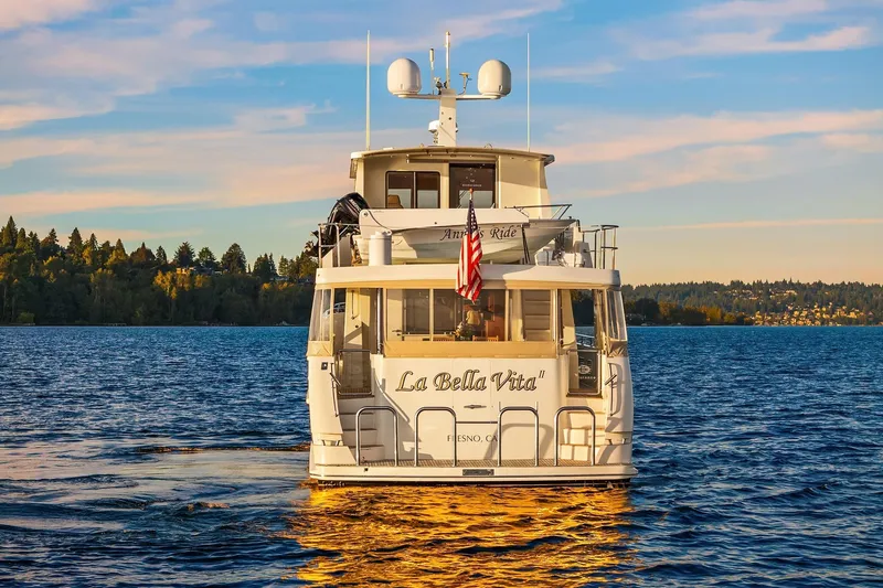 La Bella Vita II Yacht Photos Pics 2014 Hampton 720 Skylounge LRC yacht on serene lake at sunset.