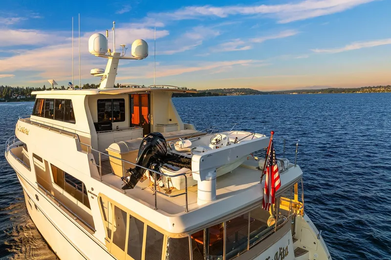 La Bella Vita II Yacht Photos Pics Luxury 2014 Hampton 720 Skylounge LRC yacht cruising on serene waters at sunset.