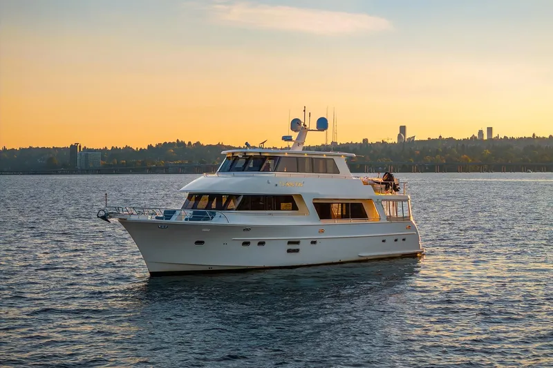 La Bella Vita II Yacht Photos Pics Luxurious 2014 Hampton 720 Skylounge LRC yacht cruising at sunset on serene waters.