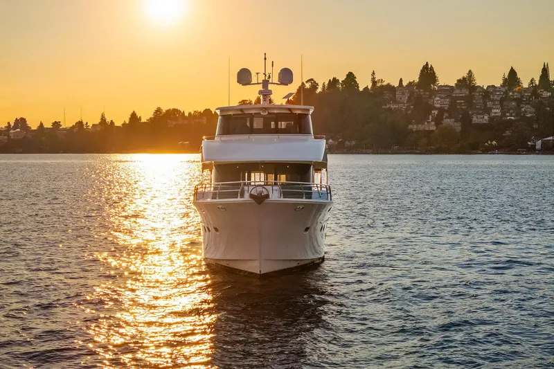 La Bella Vita II Yacht Photos Pics 2014 Hampton 720 Skylounge LRC yacht at sunset on tranquil water.