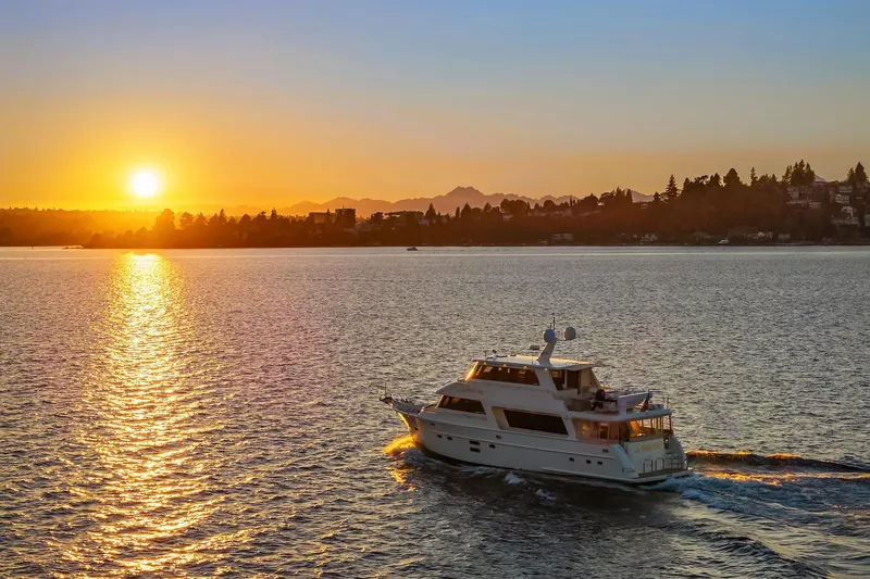 La Bella Vita II Yacht Photos Pics Luxury yacht Hampton 720 Skylounge LRC cruising at sunset on serene waters, 2014 model.