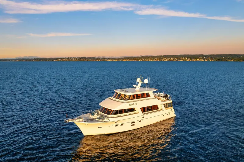 La Bella Vita II Yacht Photos Pics Luxury yacht Hampton 720 Skylounge LRC 2014 cruising on serene blue waters at sunset.