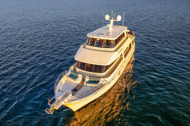 La Bella Vita II Yacht Photos Pics Luxurious 2014 Hampton 720 Skylounge LRC yacht cruising on serene blue waters.
