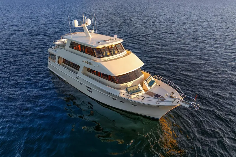 La Bella Vita II Yacht Photos Pics Luxurious 2014 Hampton 720 Skylounge LRC yacht cruising on open water.