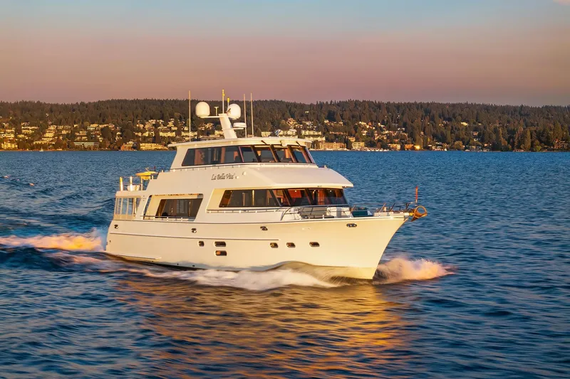 La Bella Vita II Yacht Photos Pics 2014 Hampton 720 Skylounge LRC yacht cruising on a scenic lake at sunset.