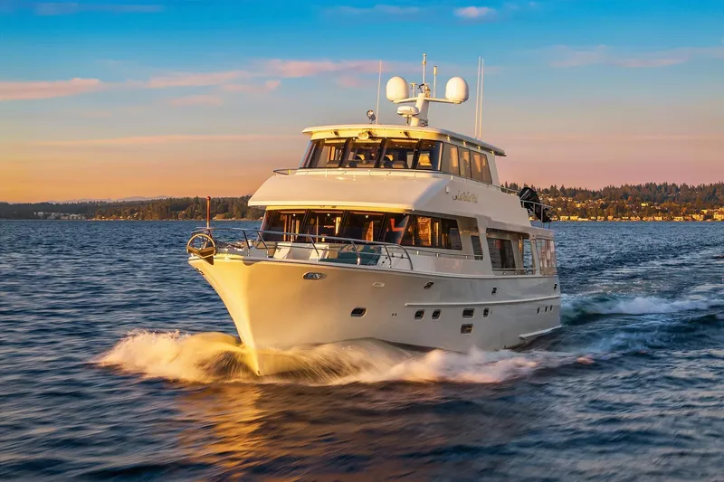 La Bella Vita II Yacht Photos Pics Luxurious 2014 Hampton 720 Skylounge LRC yacht cruising at sunset on open water.