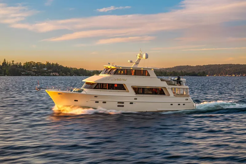 La Bella Vita II Yacht Photos Pics 2014 Hampton 720 Skylounge LRC yacht cruising on a serene lake at sunset.