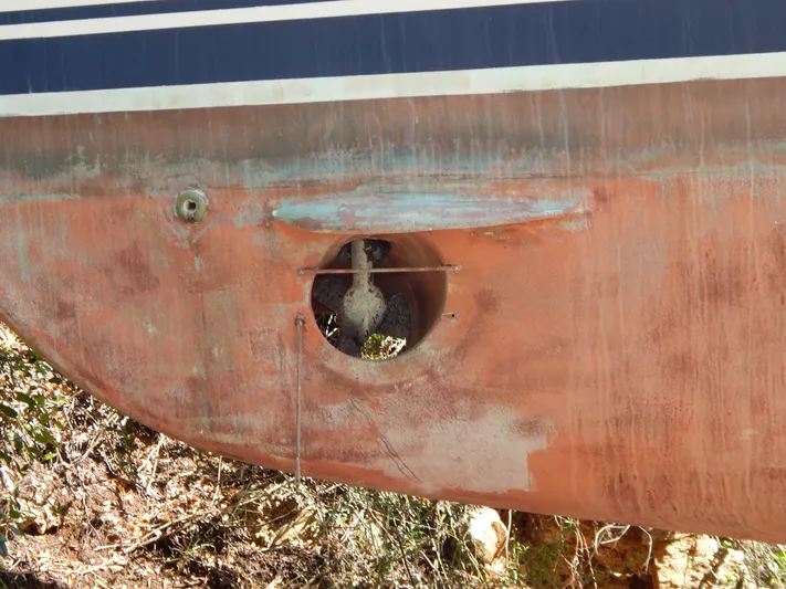  Yacht Photos Pics Close-up of a 1992 Tayana 55 boat hull with visible propeller and wear.