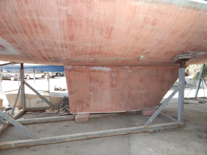  Yacht Photos Pics Bottom view of a 1992 Tayana 55 sailboat on a stand, showing the keel and hull.