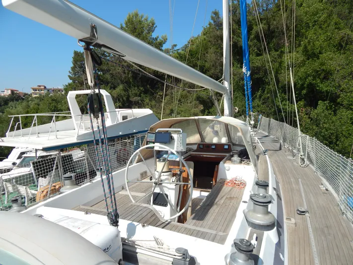  Yacht Photos Pics Sailing yacht Tayana 55, 1992 model, docked with lush greenery in the background.