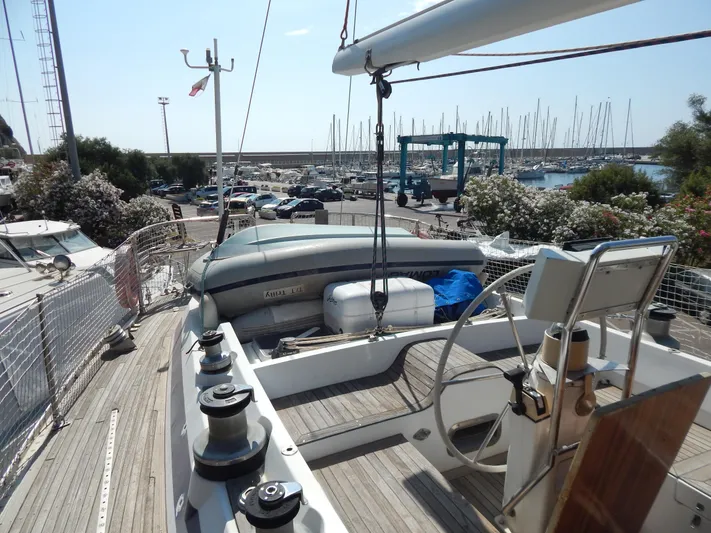  Yacht Photos Pics Deck view of 1992 Tayana 55 sailboat in marina, featuring steering wheel and winches.