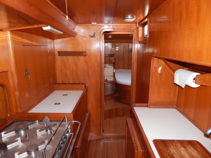  Yacht Photos Pics Interior of 1992 Tayana 55 yacht with wooden cabinetry and compact kitchen area.