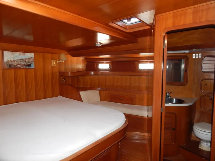  Yacht Photos Pics Luxurious wooden interior of 1992 Tayana 55 yacht cabin with bed and bathroom.