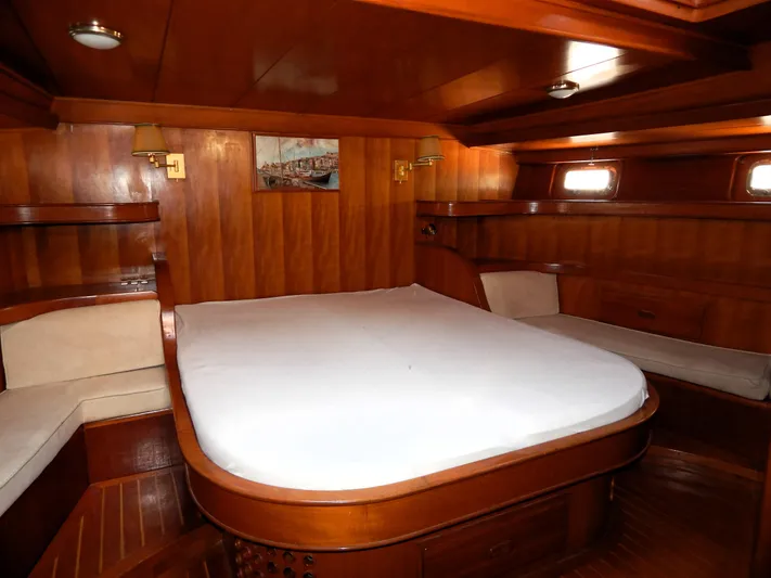  Yacht Photos Pics Luxurious wooden cabin interior of 1992 Tayana 55 yacht with cozy bed and seating.