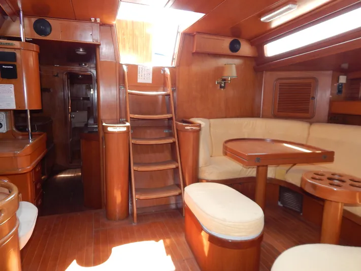 Yacht Photos Pics Interior of 1992 Tayana 55 yacht with wooden finish and cozy seating area.