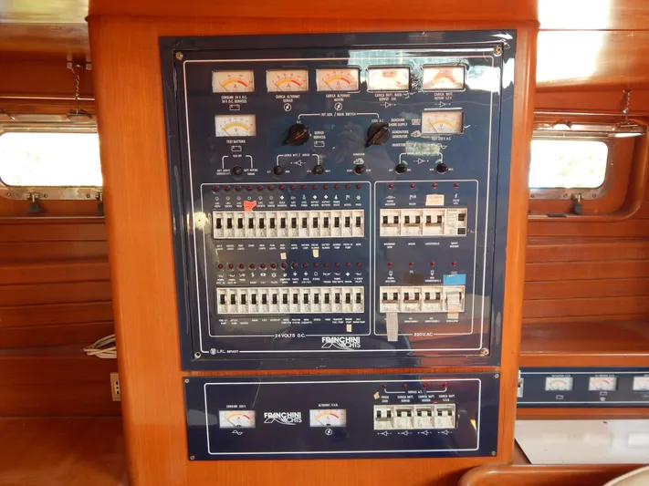  Yacht Photos Pics Electrical panel on a 1992 Tayana 55 yacht, featuring various switches and gauges.