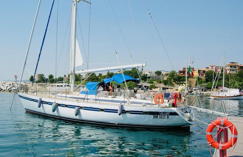  Yacht Photos Pics Sailing yacht Tayana 55, 1992 model, docked in a scenic marina.