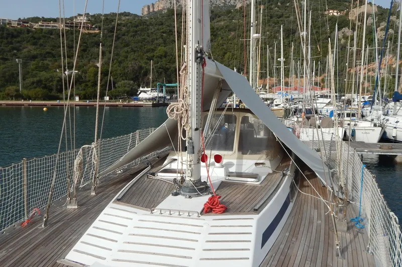  Yacht Photos Pics Sailboat Tayana 55, 1992 model, docked in a marina with scenic hillside backdrop.