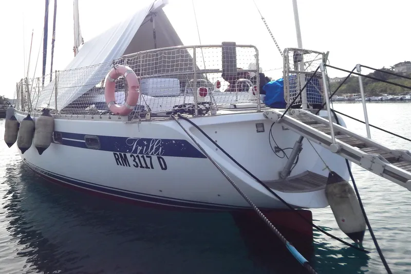 Yacht Photos Pics Sailing yacht Tayana 55, 1992 model, docked with visible lifebuoy and boarding ladder.