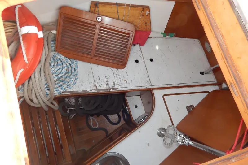  Yacht Photos Pics Interior of 1992 Tayana 55 sailboat with ropes, life preserver, and wooden panels.
