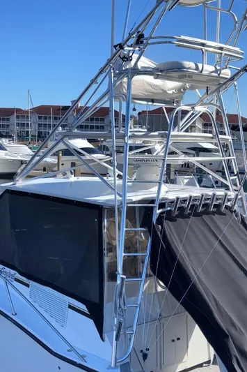 Reel Deal Yacht Photos Pics 2001 Carolina Classic 35 boat with tower, docked in marina.