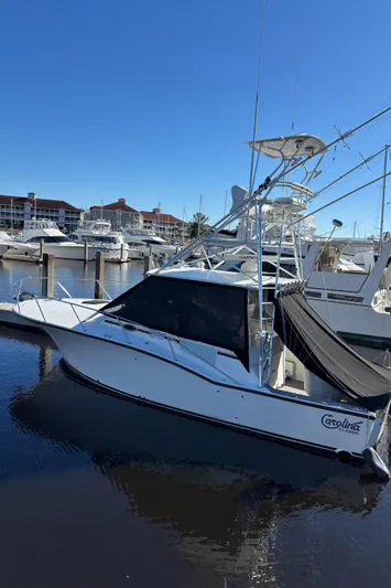 Reel Deal Yacht Photos Pics 2001 Carolina Classic 35 boat docked in marina under clear blue sky.