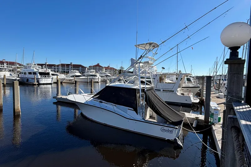 Reel Deal Yacht Photos Pics 2001 Carolina Classic 35 boat docked in a marina under clear blue skies.
