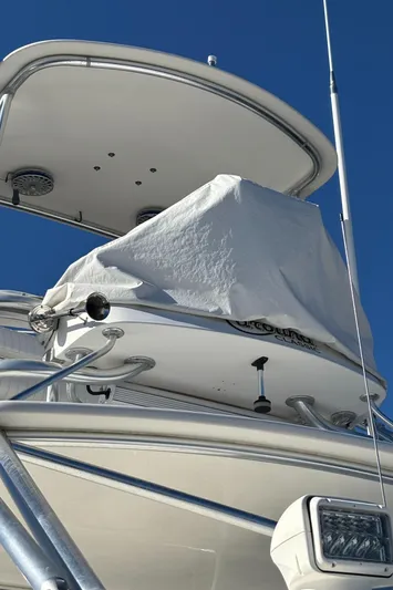 Reel Deal Yacht Photos Pics 2001 Carolina Classic 35 boat with covered equipment, blue sky background.