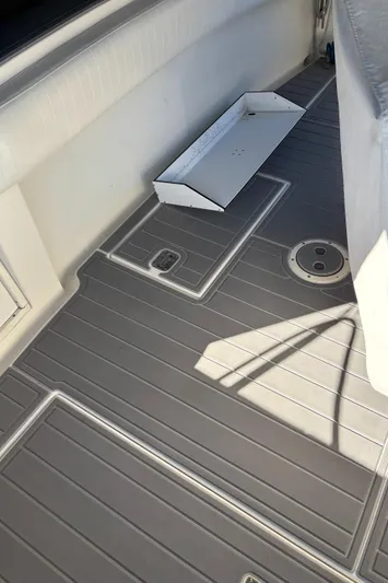 Reel Deal Yacht Photos Pics 2001 Carolina Classic 35 boat deck with gray flooring and storage compartment.