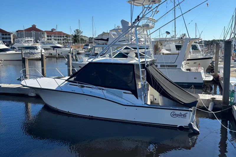Reel Deal Yacht Photos Pics 2001 Carolina Classic 35 boat docked in marina, surrounded by other vessels.