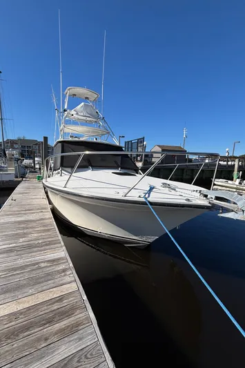 Reel Deal Yacht Photos Pics 2001 Carolina Classic 35 boat docked at marina under clear blue sky.
