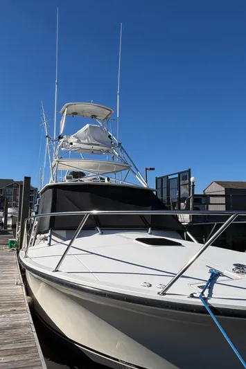 Reel Deal Yacht Photos Pics 2001 Carolina Classic 35 boat docked under clear blue sky.