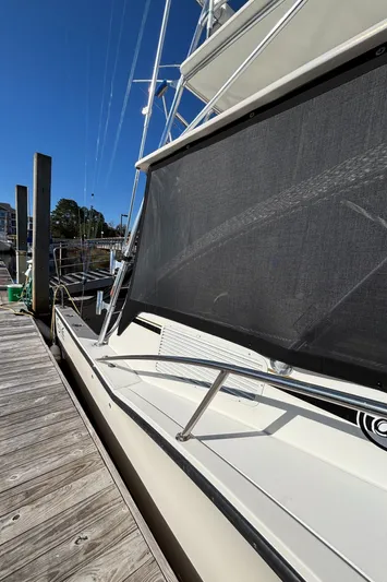 Reel Deal Yacht Photos Pics 2001 Carolina Classic 35 boat docked at marina under clear blue sky.