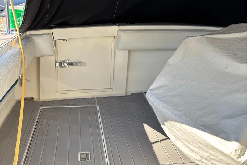 Reel Deal Yacht Photos Pics 2001 Carolina Classic 35 boat interior with covered seating and storage compartment.