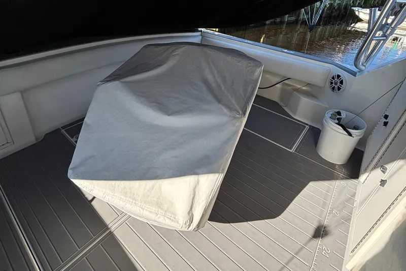 Reel Deal Yacht Photos Pics 2001 Carolina Classic 35 boat deck with covered equipment and seating area.