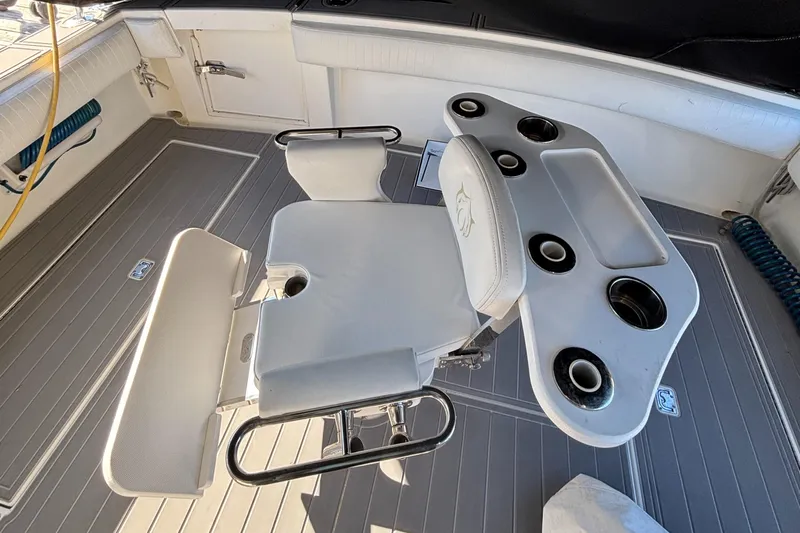 Reel Deal Yacht Photos Pics Fishing chair and rod holders on 2001 Carolina Classic 35 boat deck.