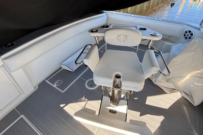 Reel Deal Yacht Photos Pics 2001 Carolina Classic 35 boat interior with white seating and rod holders.