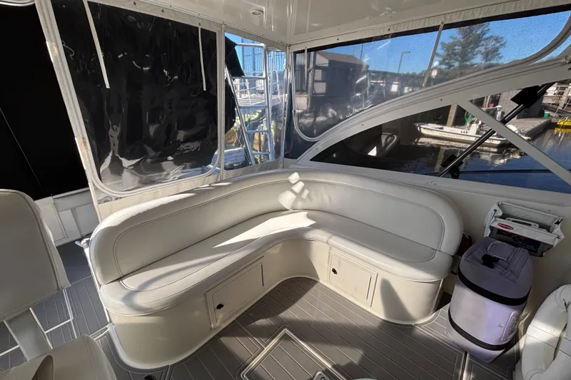 Reel Deal Yacht Photos Pics Interior of 2001 Carolina Classic 35 boat with white seating and large windows.