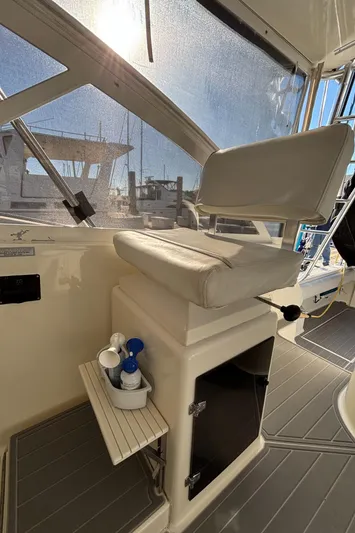 Reel Deal Yacht Photos Pics 2001 Carolina Classic 35 boat interior with captain's chair and storage compartment.