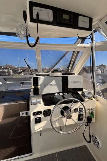 Reel Deal Yacht Photos Pics 2001 Carolina Classic 35 boat helm with Garmin navigation system and steering wheel.