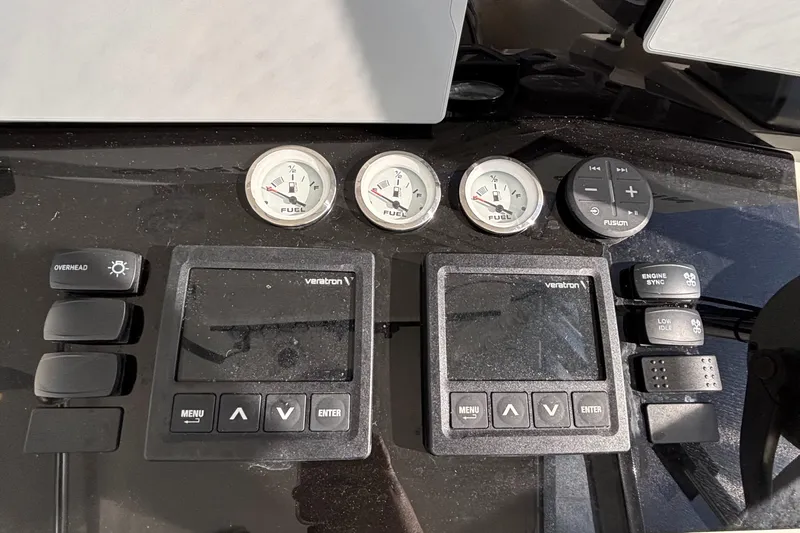 Reel Deal Yacht Photos Pics Control panel of a 2001 Carolina Classic 35 boat with gauges and buttons.